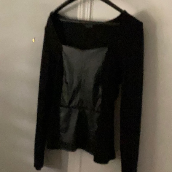 Long sleeves peplum style top with faux leather down front. - Picture 1 of 3